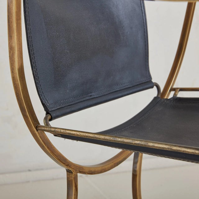A rare ‘Pompeii’ black leather and bronze armchair designed by Italian designer Alberto Orlandi. This Neoclassical chair...