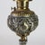 An antique American Victorian figural table lamp, crafted circa 1890, showcasing a harmonious blend of brass and silver-...