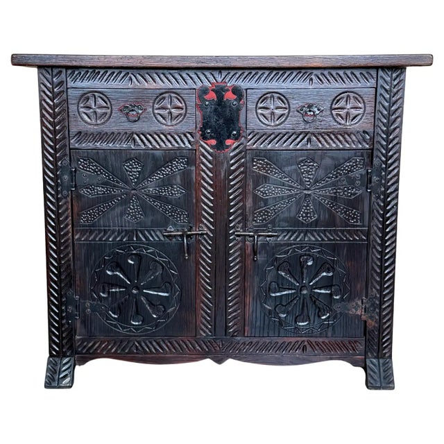 From Northern Spain, constructed of solid walnut, the rectangular top with molded edge atop a conforming case housing two...