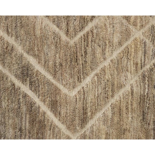 Earth in motion: bold ivory lines sweeping across bands of warm, weathered taupe. A richly layered field of light taupe,...