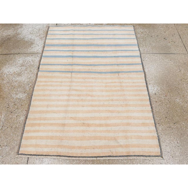 This mid-20th-century Turkish Anatolian throw rug presents a quietly modern striped composition in soft ivory, warm beige,...