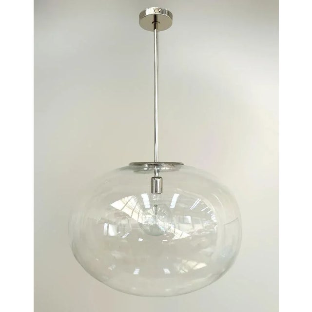 Italian pendant with a large clear Murano pebble glass shade mounted on brass frame in polished chrome finish / designed...