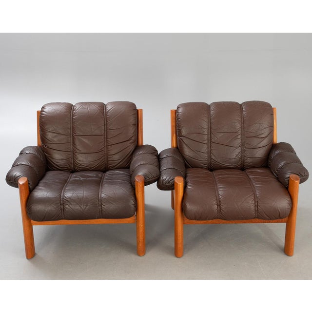 Dimensions: H 29.1” x W 34.6” x D 33” x SH 15.7” Pair of Vintage Scandinavian Ekornes “Montana” teak armchairs with brown...