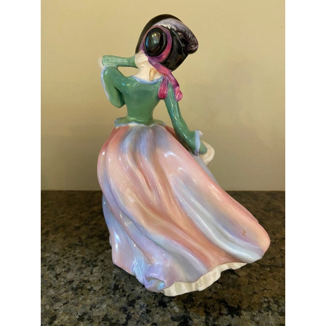 Beautiful, Royal Daulton figurine, Autumn Breezes. This is a rare and discontinued piece depicting a young woman in a...