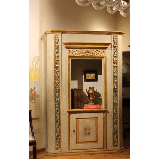 Crafted in Venice, Italy, during 19th Century, these elegant faux marble lacquer and parcel gilt display cabinets feature...
