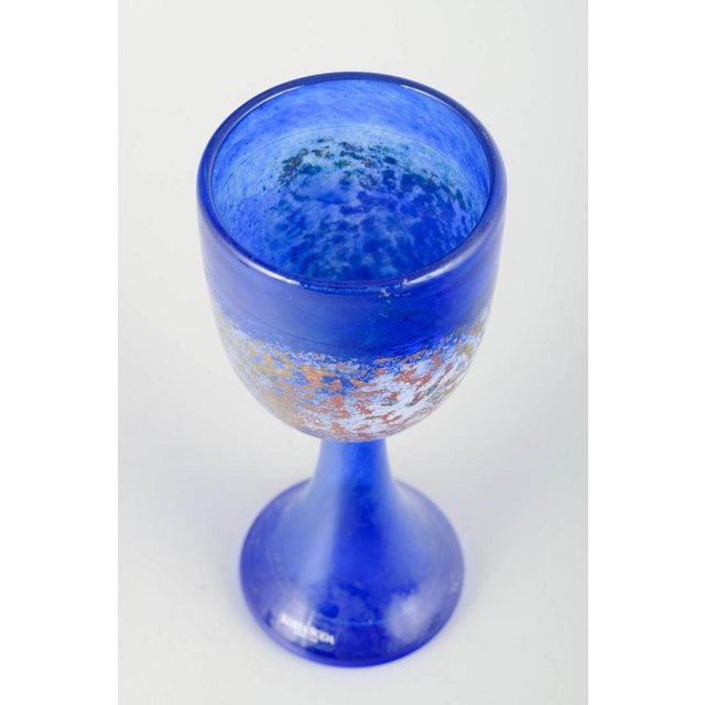 Kjell Engman for Kosta Boda Art glass wine glass, 1980/90s. Artistically crafted wine glass in blue glass with a metallic...