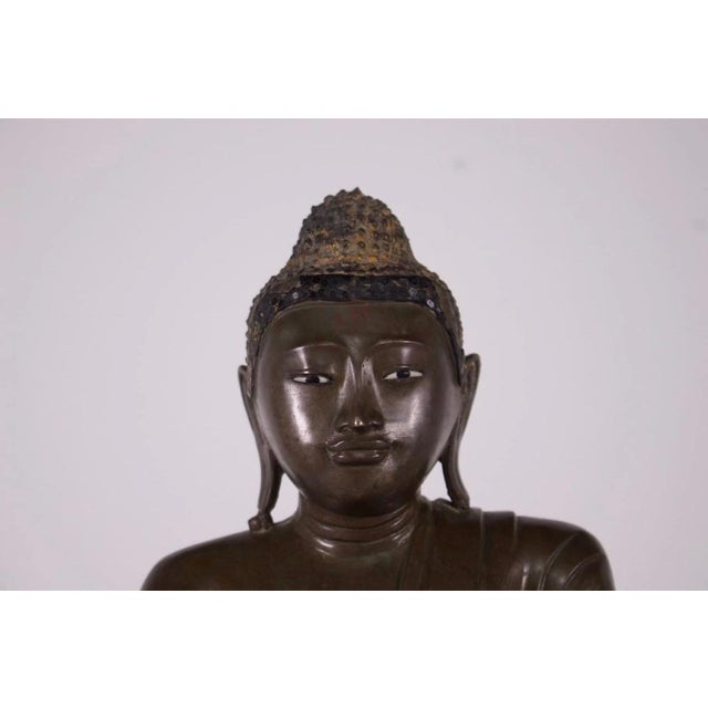 Old image of the historical bronze buddha, burma (myanmar), mandalay period, circa 1880. Shakyamuni's gaze is realistic,...