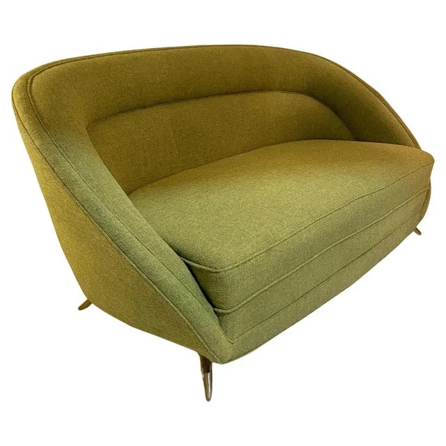 Italian two seater sofa in spring green cotton-linen fabric stands on curved cast brass legs, attributed to ISA Bergamo...