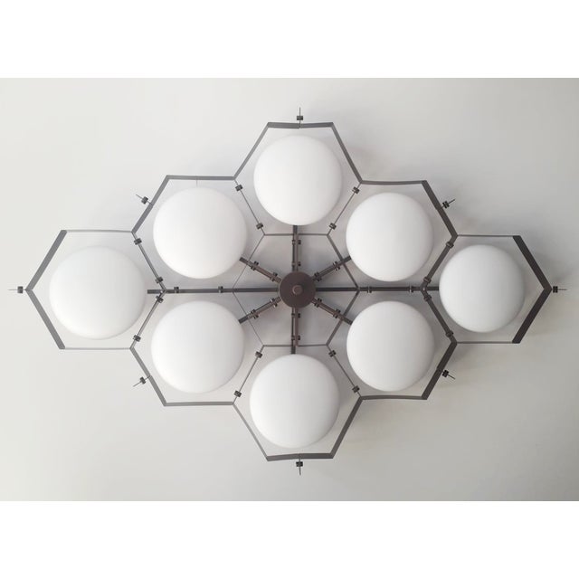 Italian midcentury flush mount with eight matte white Murano glass shades mounted on solid brass frame in bronze finish /...