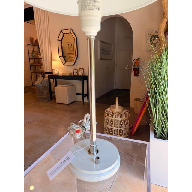 This mid-century modern inspired table lamp showcases a sleek, minimalist silhouette with clean lines and understated...