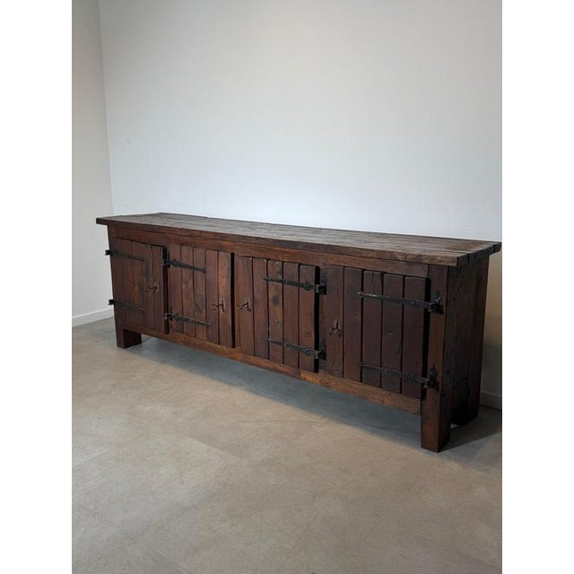 Impressive vintage brutalist sideboard crafted from solid wood, defined by its substantial proportions, raw construction...