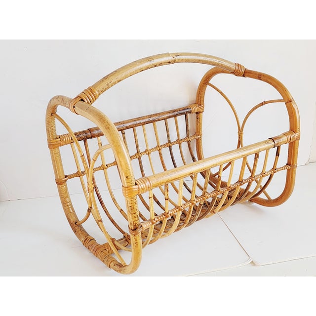 Mid-Century Boho style handcrafted bamboo and rattan magazine rack or organizer. Featuring a bent cane handle and details...