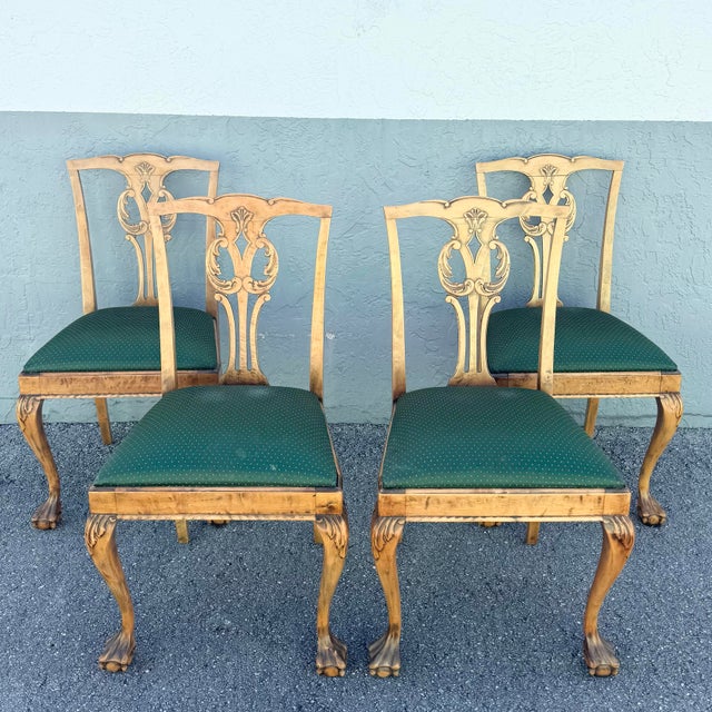 A refined set of vintage Chippendale-style dining chairs, showcasing timeless craftsmanship and elegant detailing. Each...