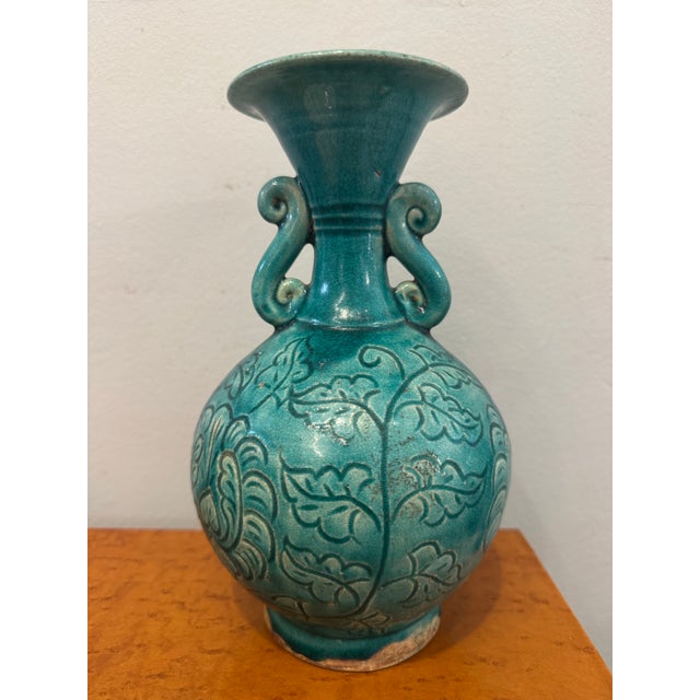 This is an antique chinoiserie style porcelain vase. It has a glossy coat. In the style, it is often referred to as...
