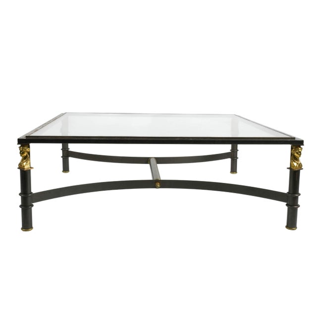 This distinctive glass top coffee table presents a compelling interplay of modernist structure and classical...