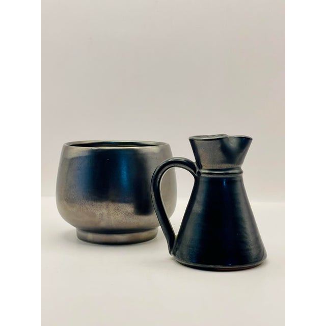 Creamer measures 3 inches tall, 1 1/2 inches at the opening and 2 1/4 inches at the foot. Sugar measures 3 inches at the...