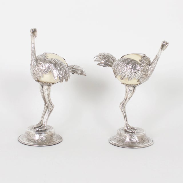 Fanciful pair of Mid-Century ostrich bird sculptures constructed with ostrich eggs and silvered metal. Wearing a quizzical...