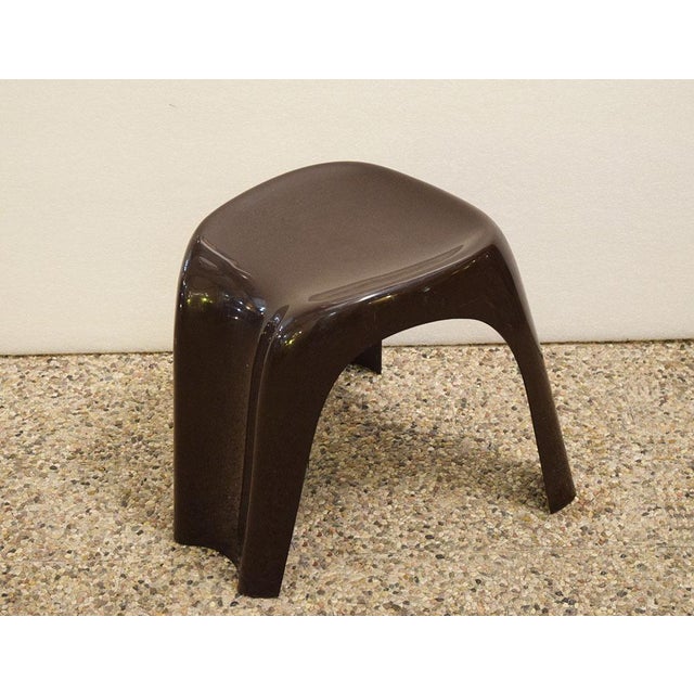 Bilumen ‘Stacki’ stool designed by Giorgina Castigloni, 1970s. Made of dark brown plastic, anatomically shaped with three...