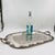 Vintage silverplate tray featuring raised grape-and-vine motifs along the border and a central etched design with...
