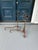 A striking pair of antique wrought iron andirons featuring beautifully hand-forged scrollwork and classic early hearth...