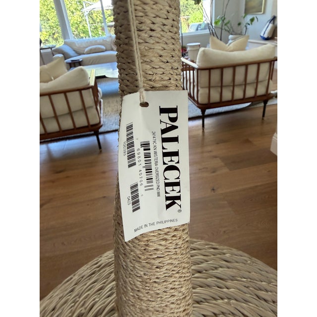 Oversized pendant with hand-woven wicker in a whitewash finish accented with a hand-twisted whitewash lampakanai rope...