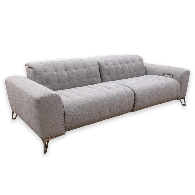 A Contemporary three-seat sofa designed by Sacha Lakic for Roche Bobois. Upholstered in grey fabric with hand-finished...