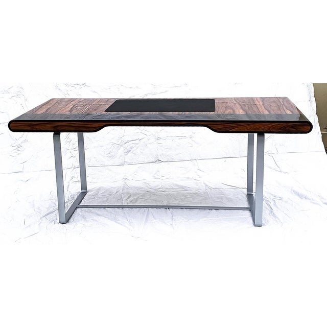 "Little Shanghai" desk in Santos wood, with silver-patinated legs. It features two drawers on each side. This desk is...