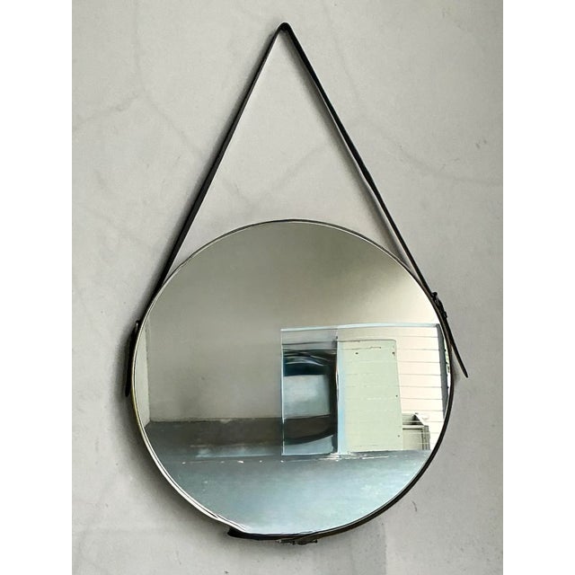 This striking hanging mirror perfectly fuses functional design with contemporary elegance, showcasing a timeless aesthetic...