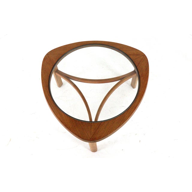 Beautiful vintage triangular coffee table with a round glass top. Originally from England and in very nice and original...