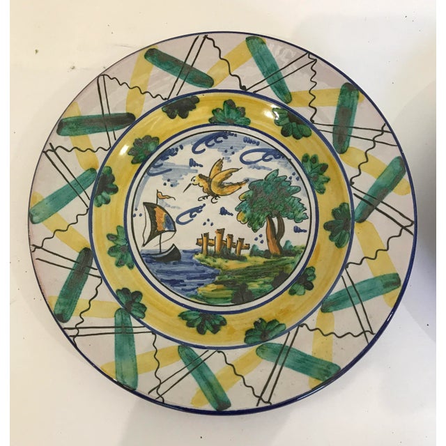 Pair of wall hanging hand painted plates. Bright, cheerful colors and all hand painted with a high gloss majolica glaze....