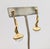 1990s goldtone long drop with round clear melon rhinestone at the bottom pierced push back earrings. Marked "TRIFARI TM"...