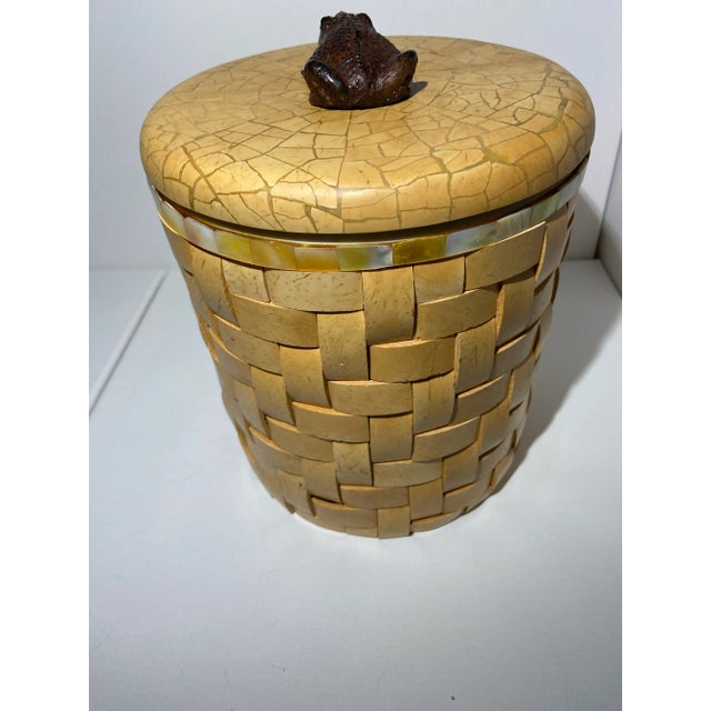 This is a beautiful and unique ice box crafted from wood and inlaid with mother-of-pearl. The box is circular in shape...