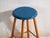 This antique wooden stool is a three-legged seat with a round seat and turned splayed legs joined by stretchers. It...