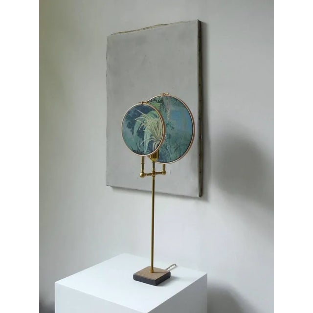 Light object, floor lamp, circle blue grey handmade in brass, leather, wood, hand printed and painted linen. A dimmer is...