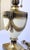 A striking vintage table lamp featuring a substantial cream enamel urn raised on a square pedestal base and adorned with...
