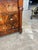 A handsome French 19th century Empire commode featuring a richly figured walnut veneer, elegant black marble top, and...