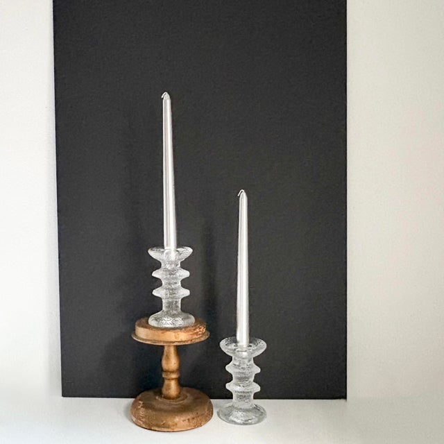 This pair of textured glass candlestick holders designed by Timo Sarpaneva for Iittala is nothing short of captivating....