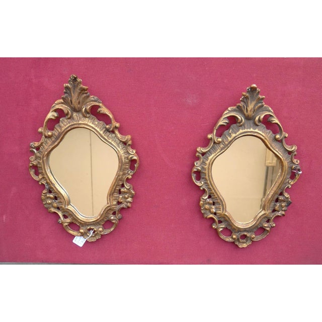 Pair of small mirrors with antique carved frames. Pair of small 20th-century mirrors in 18th-century Rococo style. Carved...