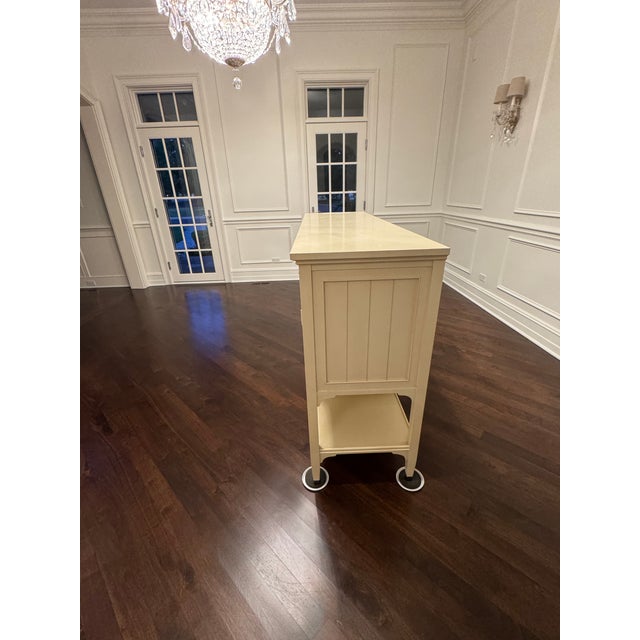 Antique ivory side board with ample storage. Good condition, very lightly used. Pewter hardware and antique mirror doors....