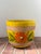 Vintage glazed terracotta planter / cachepot from Italy features a vibrant yellow background with a repeating orange...