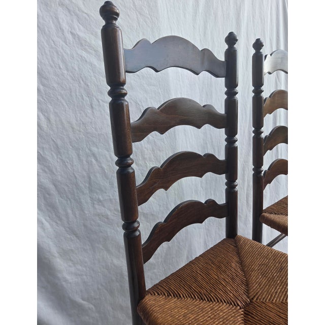 Pair of well-preserved Tell City ladder back, rush seat chairs. Original finish. Seats are in excellent condition, no stains.