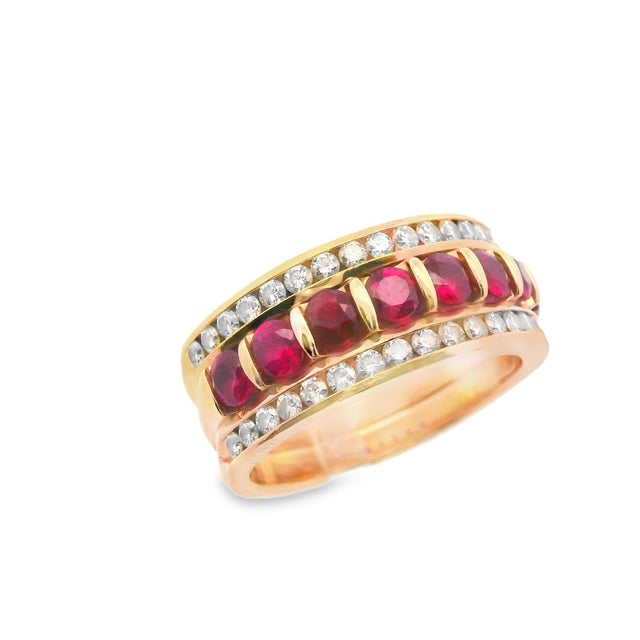 This incredible band is made in 14k yellow gold with both natural ruby and diamond. The ring is comprised of 3 total...