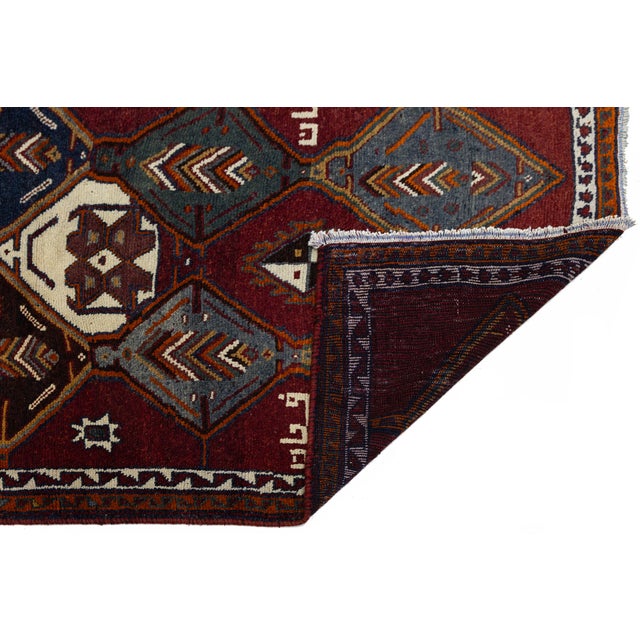 An exceptional vintage Hamadan runner featuring hand-knotted craftsmanship and authentic tribal character. Set against a...