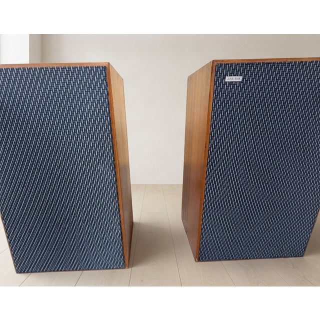 A classic pair of vintage tesla ars 825 hi-fi speakers featuring walnut-toned wooden cabinets and original dark fabric...