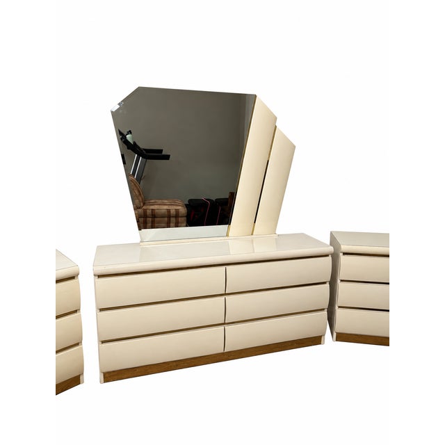 A coordinated Millennium bedroom suite featuring a six-drawer dresser, two matching three-drawer nightstands and an...