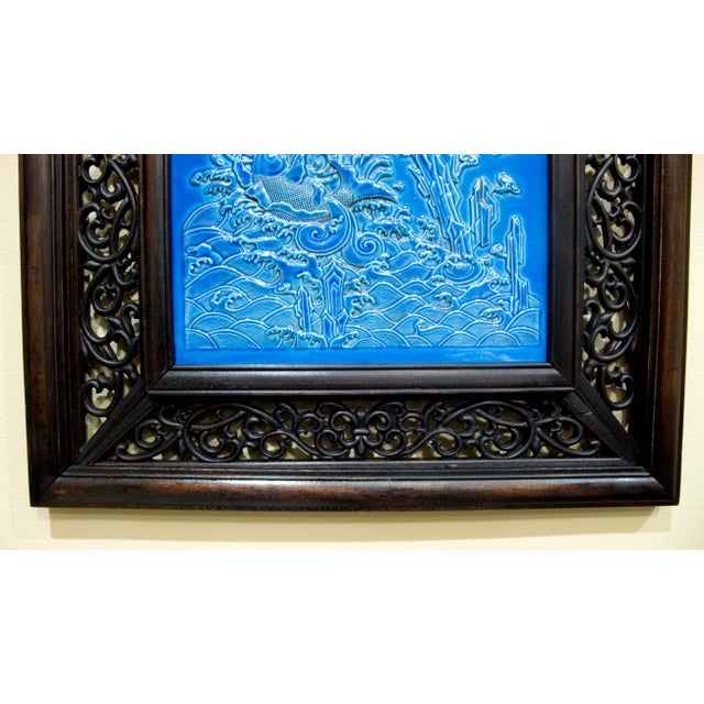 Chinese framed porcelain dragon plaque, a finely carved, five clawed, imperial, sky dragon raising the ocean waves of the...
