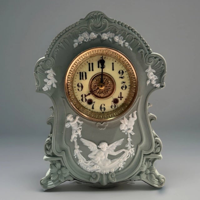 This listing is for an antique mantel clock by Gilbert. The clock is the “Cameo No. 8351” model. It features a Wedgewood...