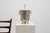 A refined Art Deco metal ice bucket distinguished by its clean geometry, polished surface, and sculptural ring handles...