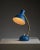 Beautiful desk lamp from Italy in a vibrant blue color with brass components. The elegant base and shade are complemented...