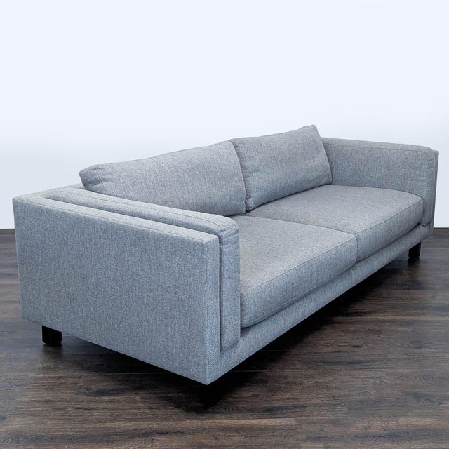 This Room and Board 3-seat sofa features a modern, boxy design with clean lines and a soft gray fabric. The spacious...